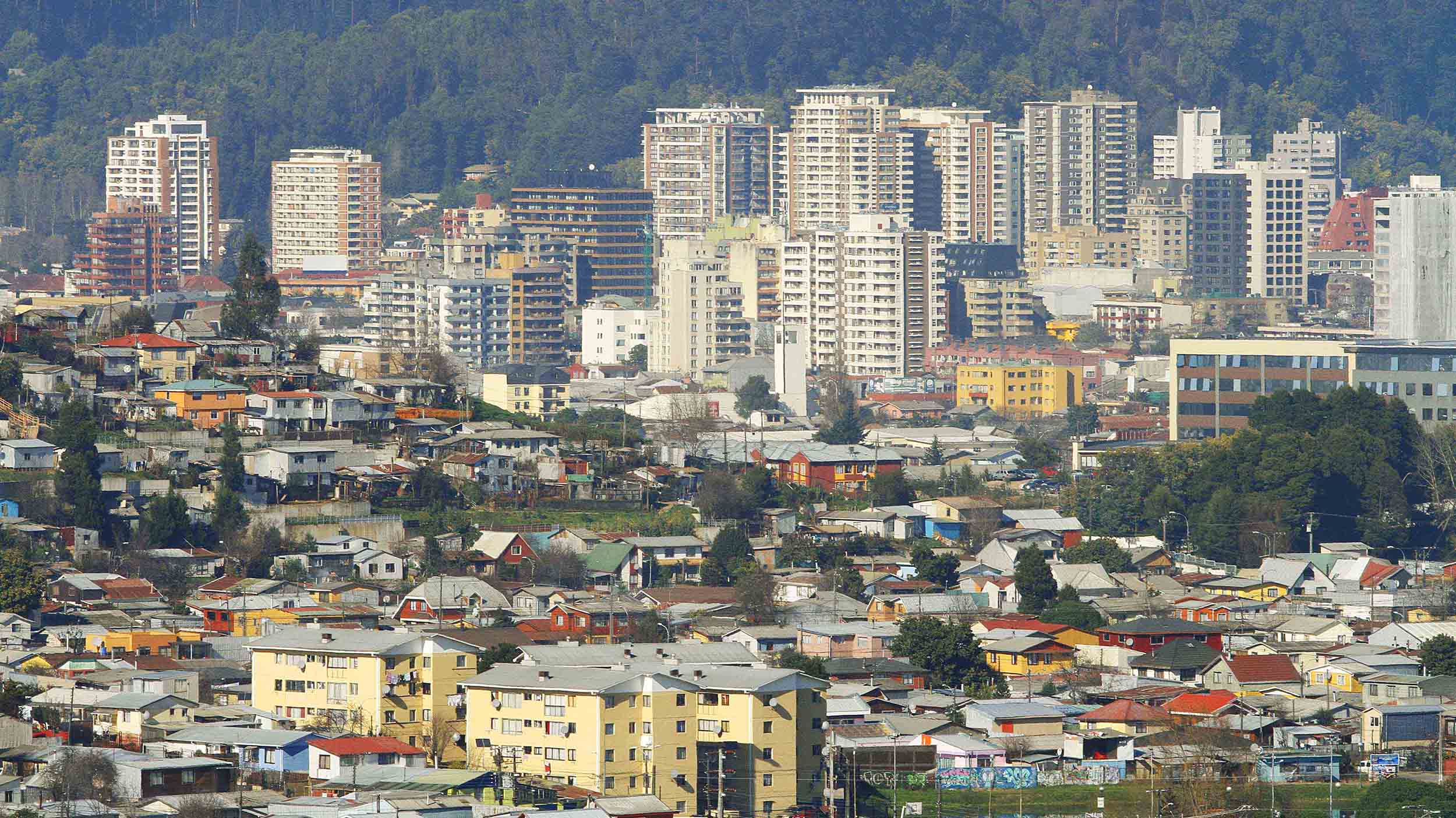 Skyline of Concepción downtown at the back, in Chile, and low density residential areas at the front of the picture